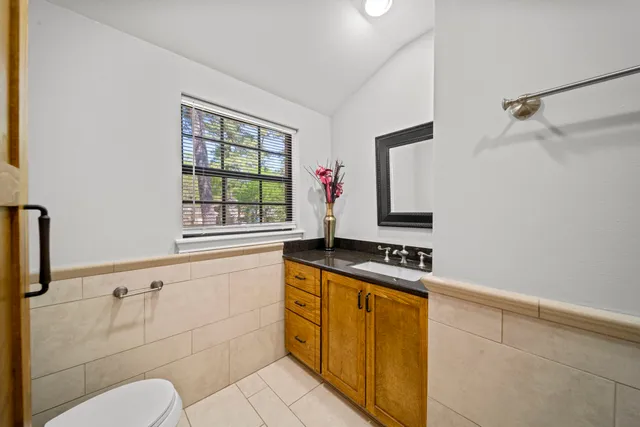 a kitchen with a stove a sink and a window