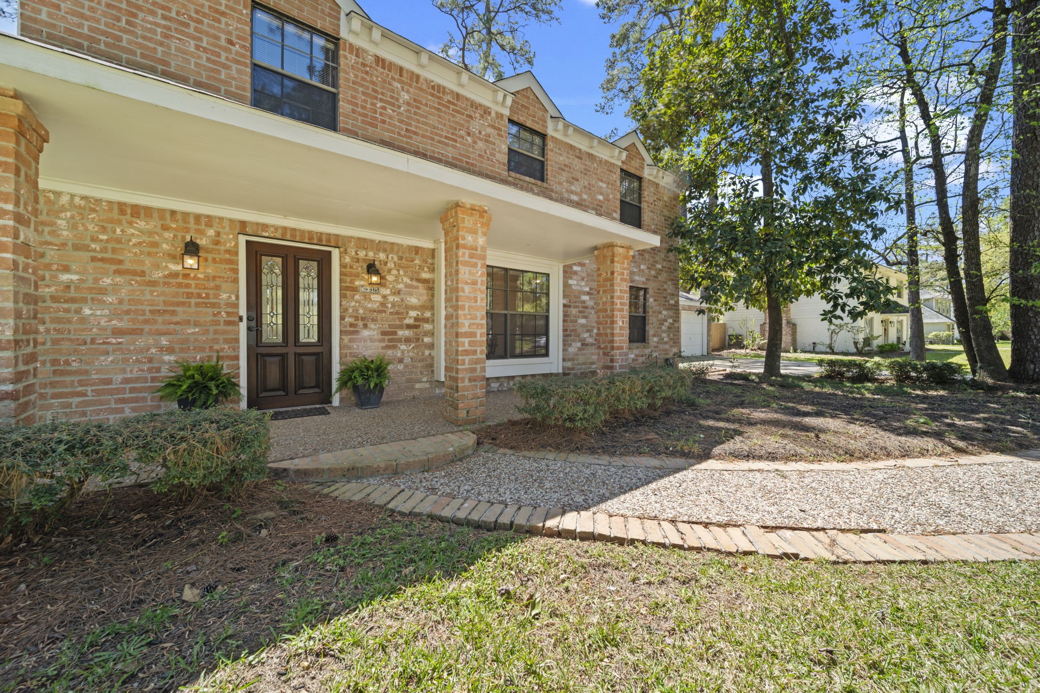 6315 Allentown Drive Spring, TX 77389 - Photo 6 of 46 a view of a brick house with many windows plants and large tree