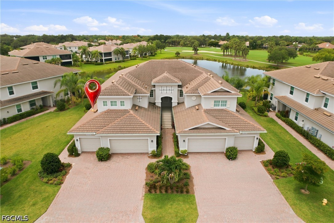 an aerial view of a house with a garden and lake view