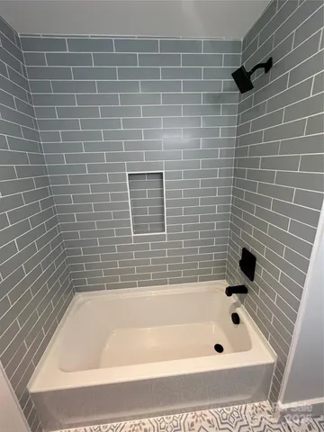 a view of walk in closet with wooden floor and stairs