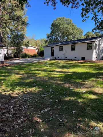 a large kitchen with stainless steel appliances granite countertop a stove and a refrigerator