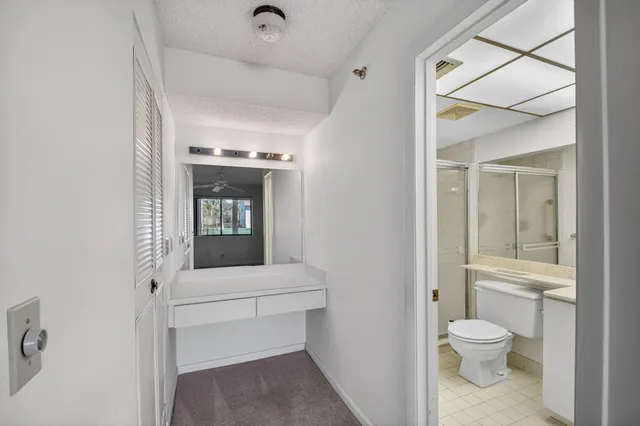 a bathroom with a toilet a sink and shower