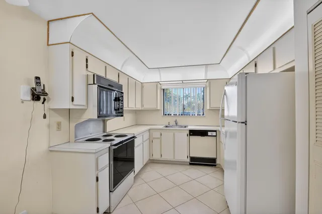 a kitchen with stainless steel appliances a refrigerator sink and stove