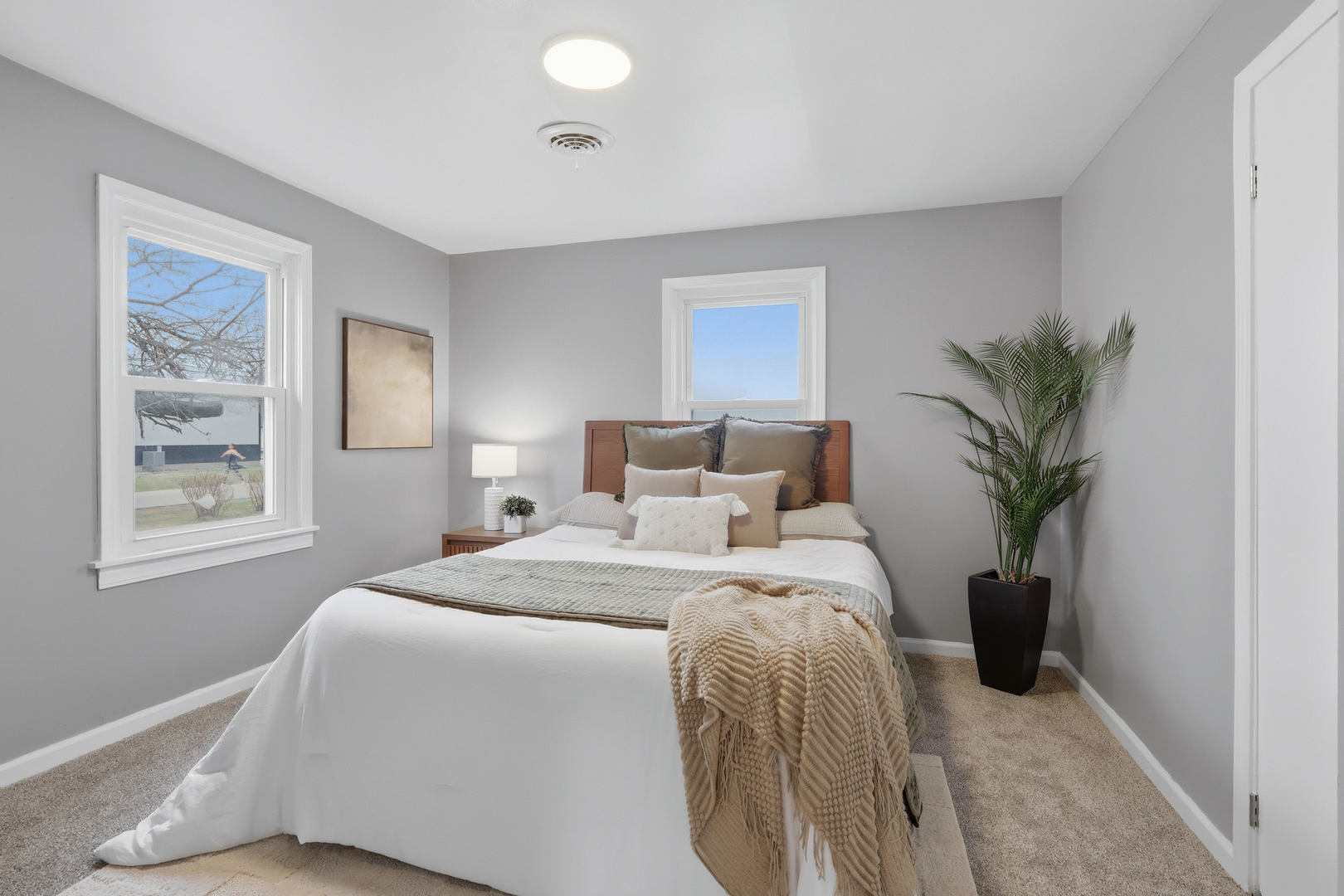 4120 4th Street East Moline, IL 61244 - Photo 8 of 24 a bedroom with a bed and a potted plant