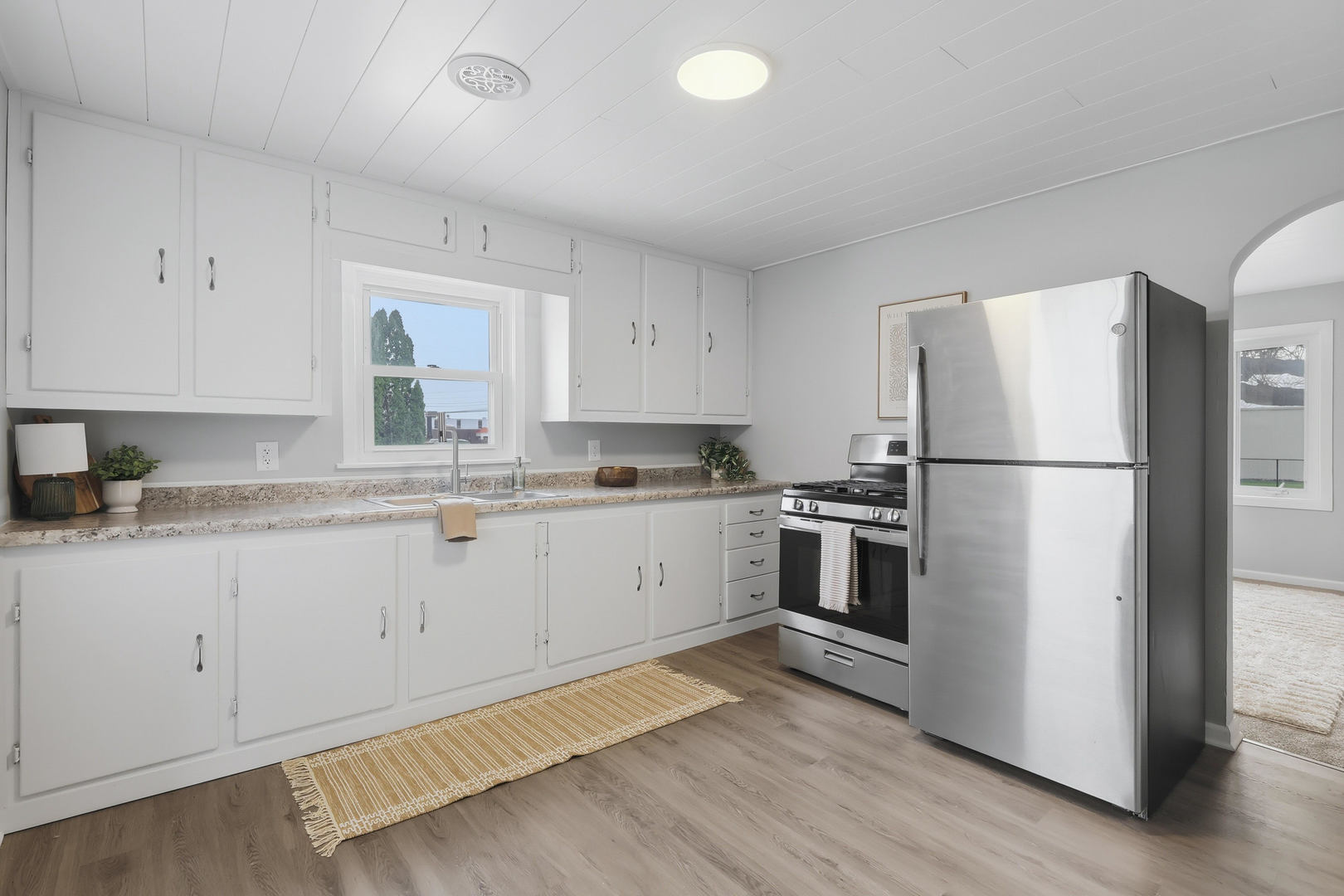 4120 4th Street East Moline, IL 61244 - Photo 10 of 24 a kitchen with stainless steel appliances granite countertop a refrigerator sink and white cabinets