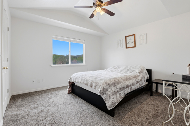 8083 North Ridge Loop East, Unit I 9 Eagle Mountain, UT 84005 - Photo 11 of 17 Bedroom with carpet flooring, vaulted ceiling, and ceiling fan