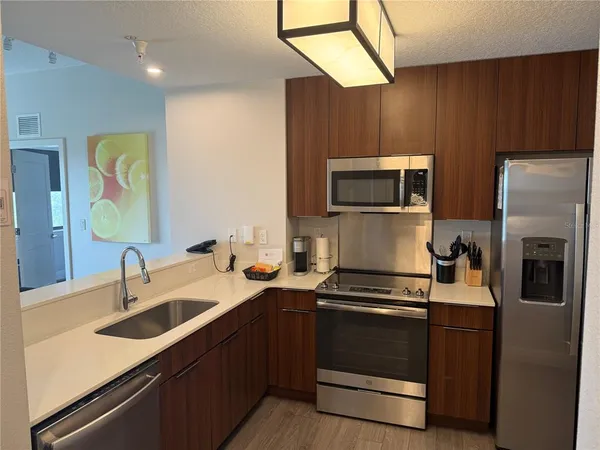 a kitchen with a sink and a stove top oven