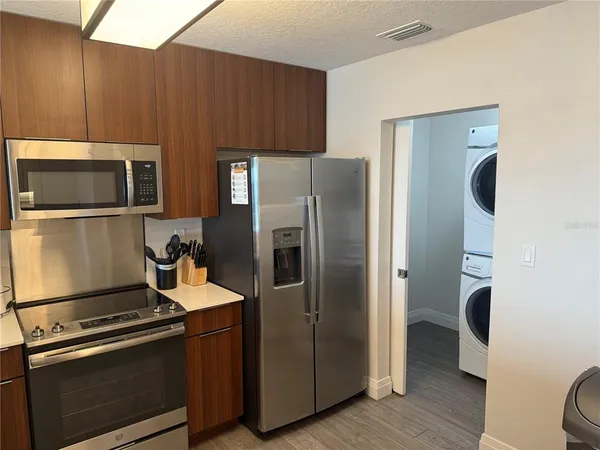 a kitchen with stainless steel appliances a refrigerator stove and microwave