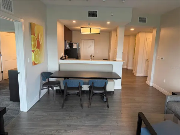 a dining room with furniture and wooden floor