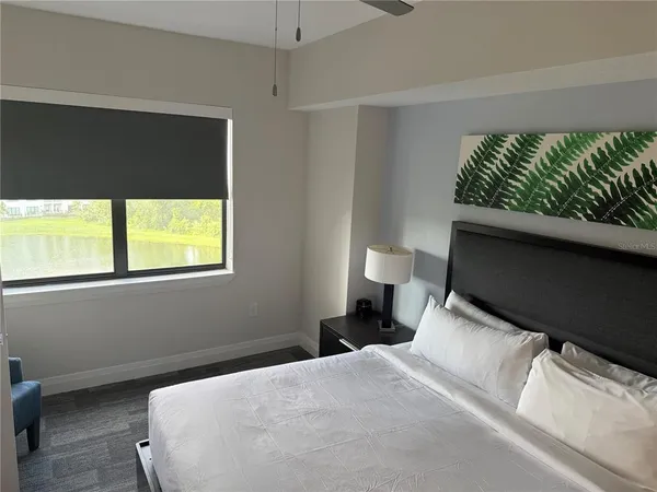 a bedroom with a bed and a window