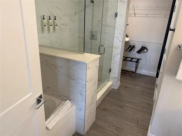 a bathroom with a tub a sink and a shower