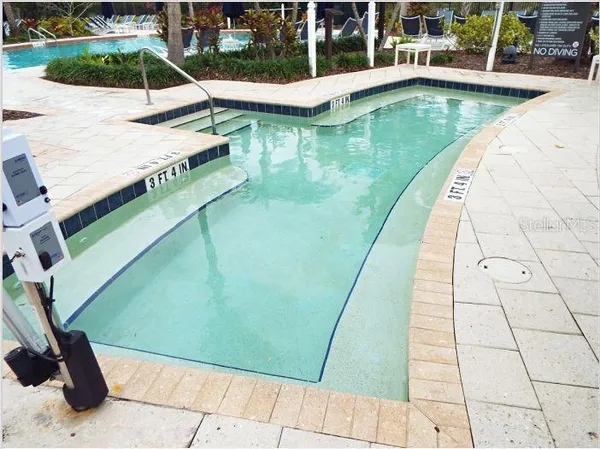 a view of a swimming pool with seating area