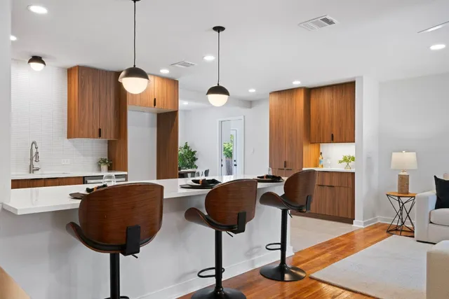 a view of kitchen and dining area with chandelier