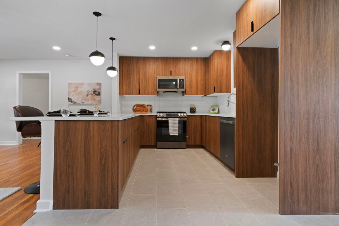 1609 Chatham Avenue Austin, TX 78723 - Photo 16 of 31 a kitchen with stainless steel appliances granite countertop a refrigerator and a sink