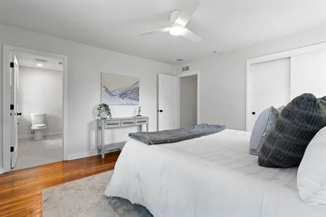 a spacious bedroom with a bed and a walk in closet