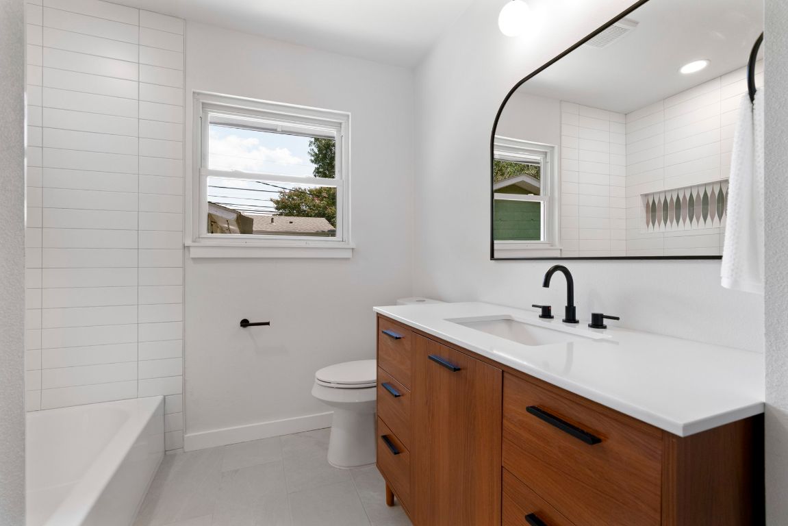 1609 Chatham Avenue Austin, TX 78723 - Photo 24 of 31 a bathroom with a sink and a mirror