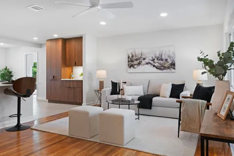 a living room with furniture and a large mirror