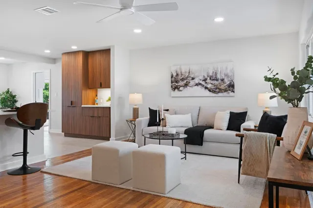 a living room with furniture and a large mirror
