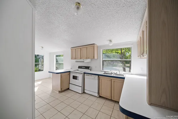 a kitchen with a sink stove and cabinets