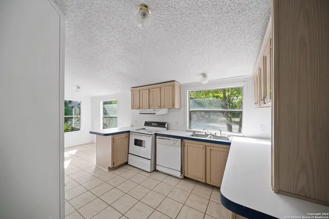 a kitchen with a sink stove and cabinets