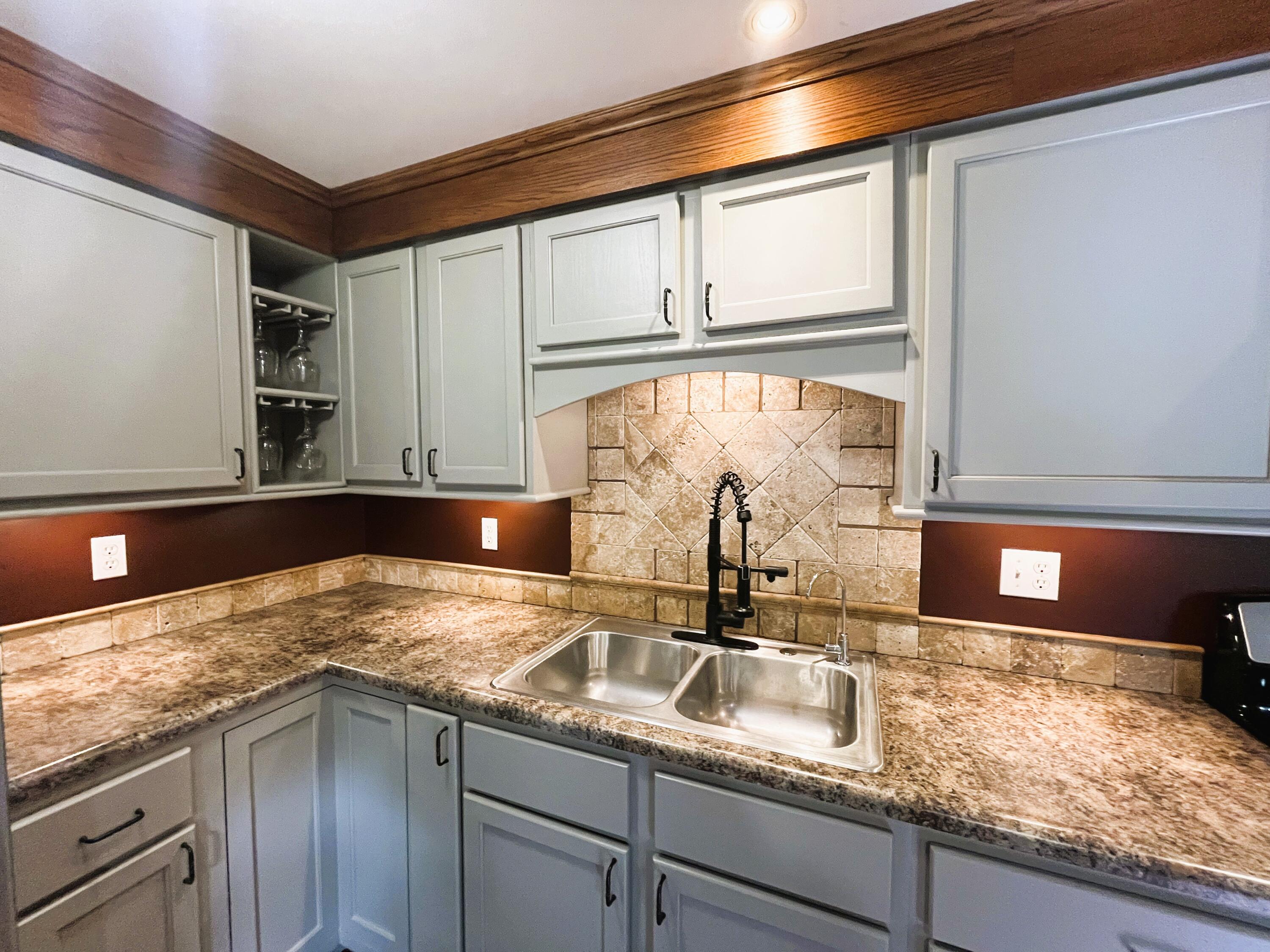 821 East Merritt Street Rensselaer, IN 47978 - Photo 12 of 18 a kitchen with granite countertop a sink and a stove