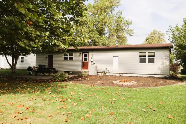 a backyard of a house with yard and outdoor seating