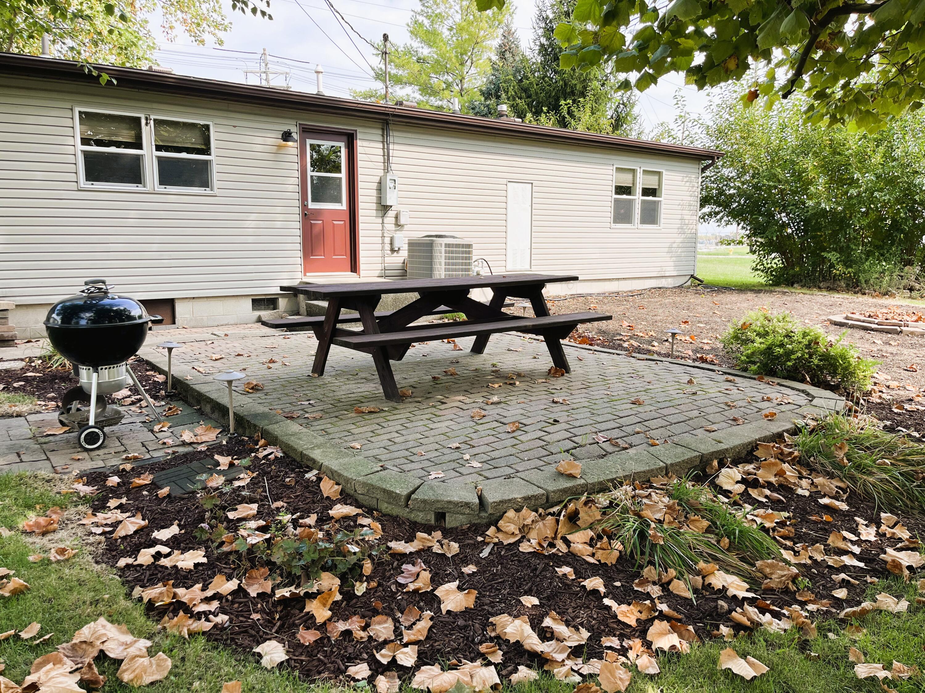 821 East Merritt Street Rensselaer, IN 47978 - Photo 3 of 18 a backyard of a house with table and chairs