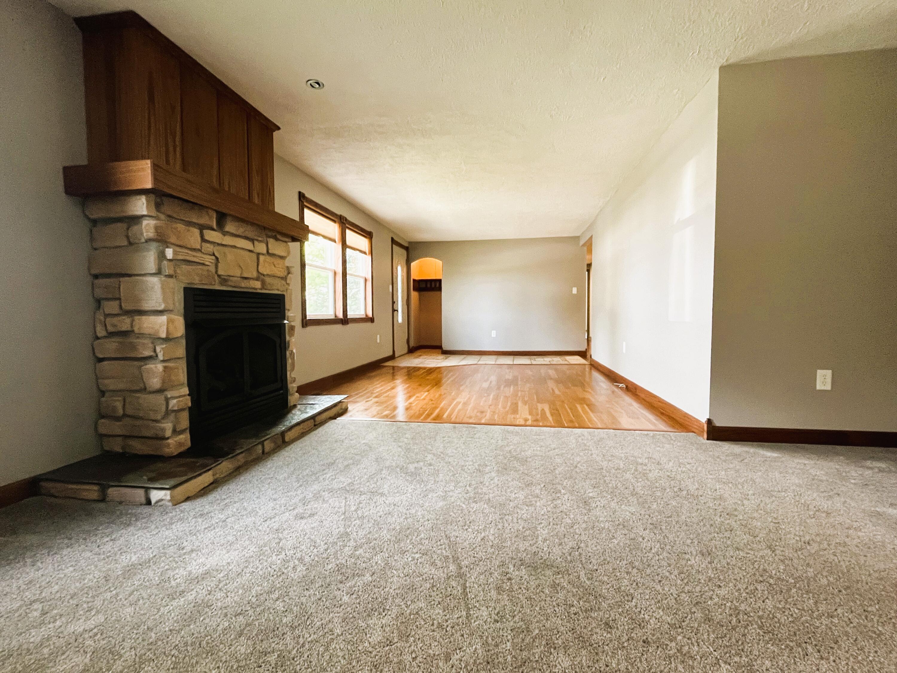 821 East Merritt Street Rensselaer, IN 47978 - Photo 6 of 18 a view of an empty room with a fireplace and a window