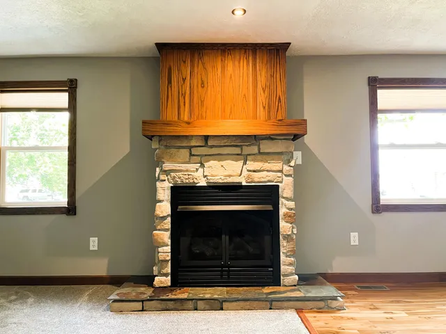 a view of a livingroom with a ceiling fan and wooden floor