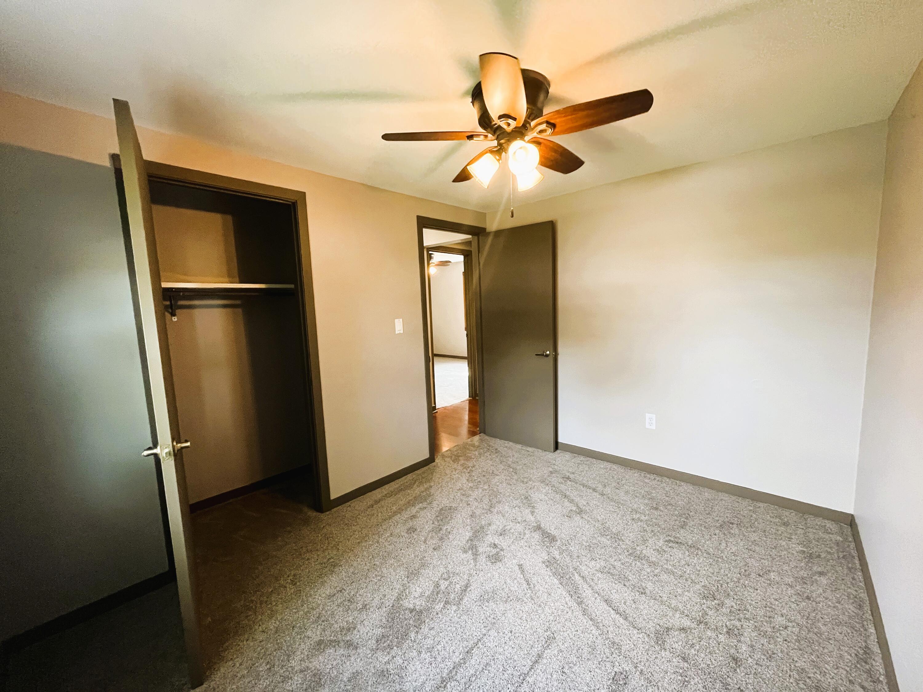 821 East Merritt Street Rensselaer, IN 47978 - Photo 8 of 18 a view of a livingroom with a ceiling fan and wooden floor