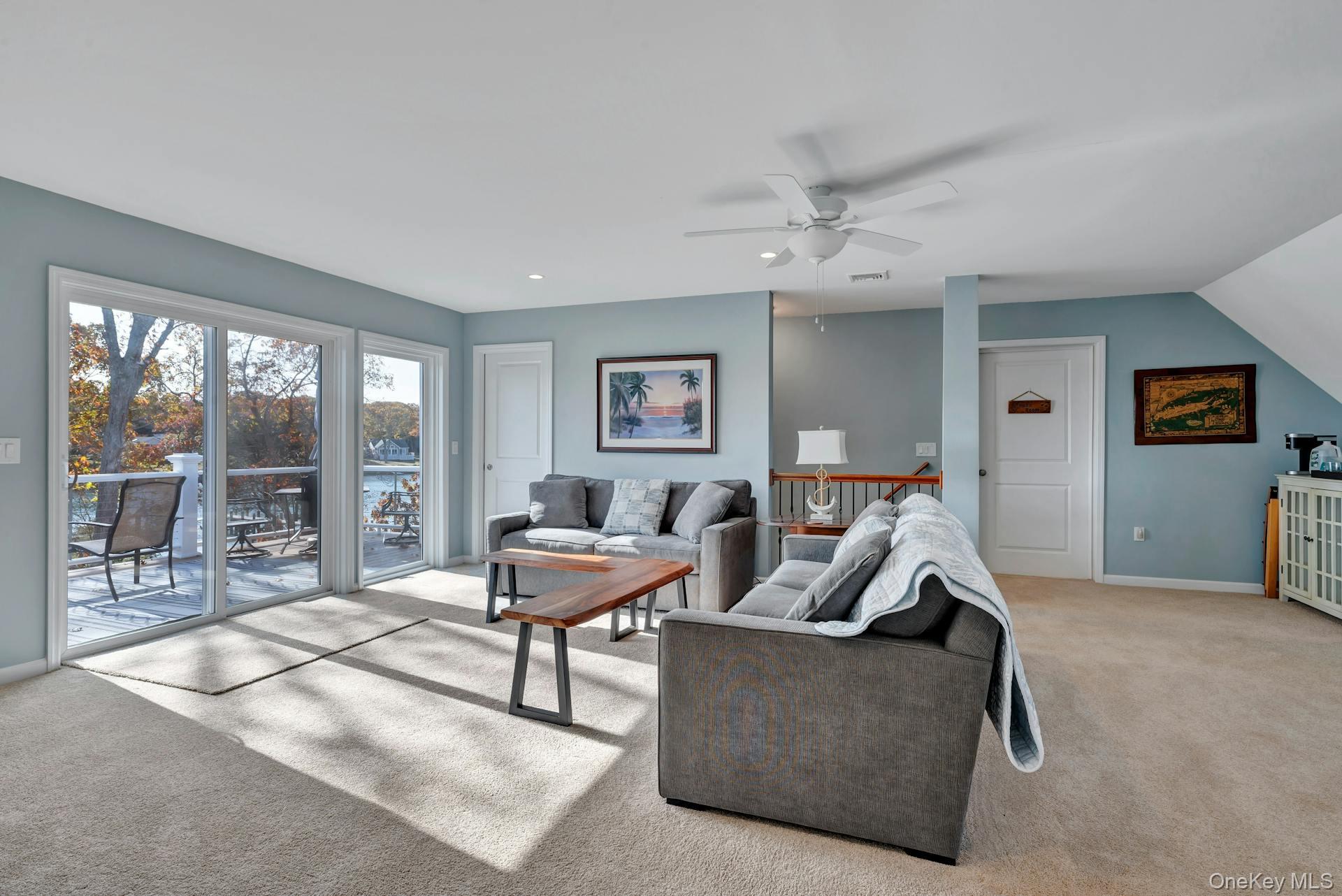 2280 Deep Hole Drive Mattituck, NY 11952 - Photo 19 of 45 Inviting family room with abundant natural light, water views and balcony access