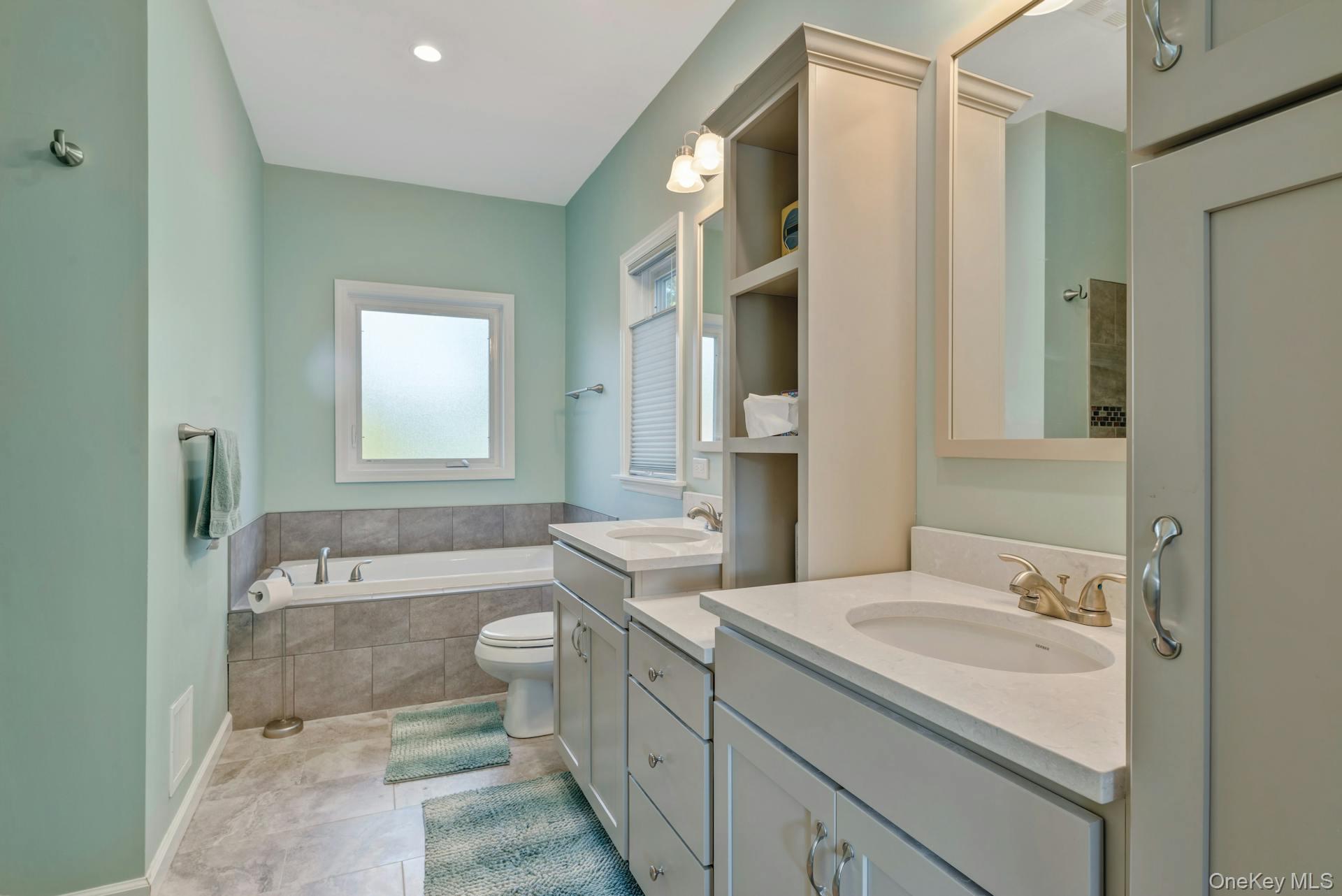 2280 Deep Hole Drive Mattituck, NY 11952 - Photo 25 of 41 a bathroom with a granite countertop sink toilet and shower
