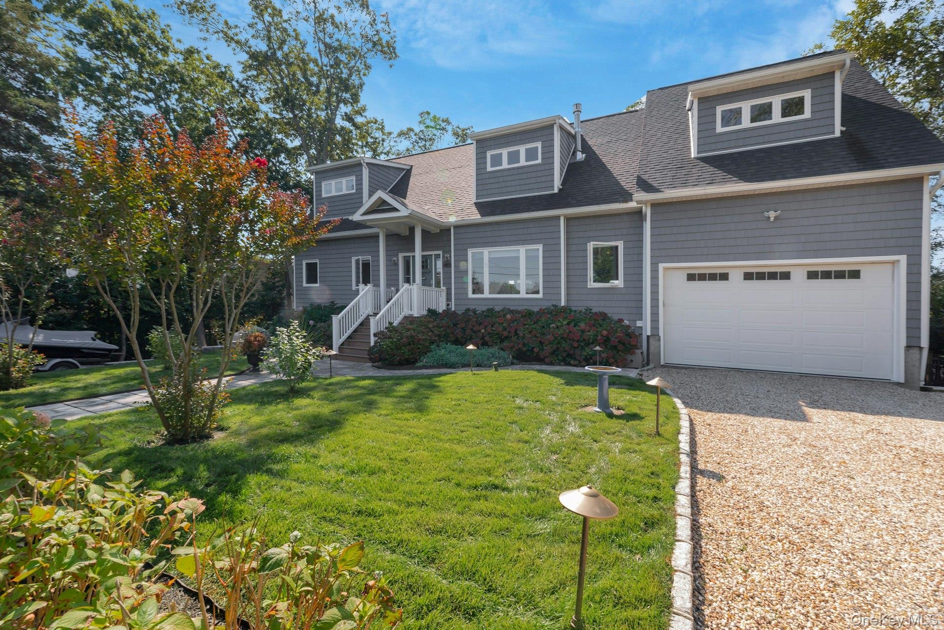 2280 Deep Hole Drive Mattituck, NY 11952 - Photo 3 of 41 a front view of a house with garden