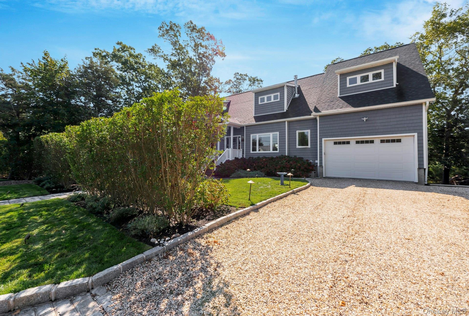 2280 Deep Hole Drive Mattituck, NY 11952 - Photo 33 of 41 a front view of a house with a yard and garage