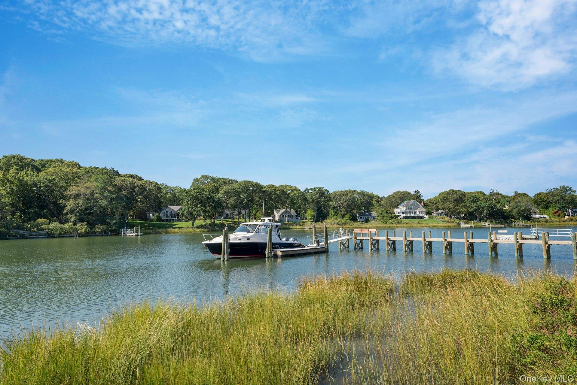 2280 Deep Hole Drive Mattituck, NY 11952 - Photo 36 of 41 a view of a lake with houses in the back