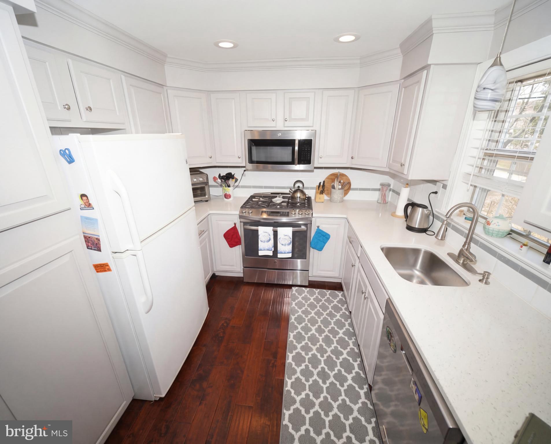 3216 Chesterfield Road Philadelphia, PA 19114 - Photo 11 of 27 a kitchen with a sink a stove a refrigerator and cabinets