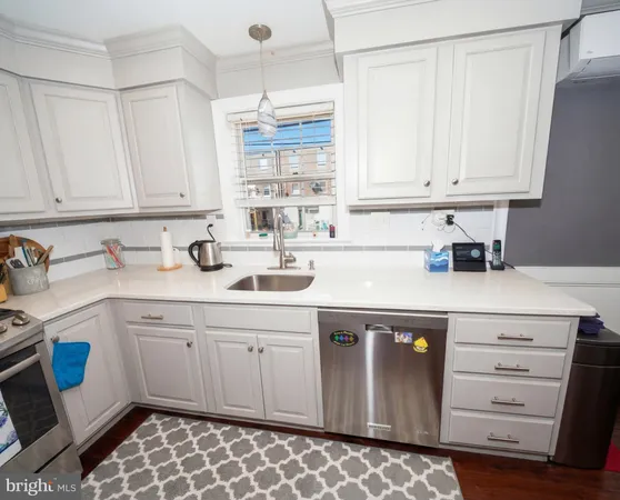 a kitchen with stainless steel appliances granite countertop a sink a stove and cabinets
