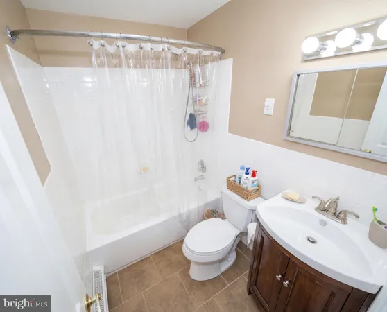 a bathroom with a sink a toilet and shower curtain