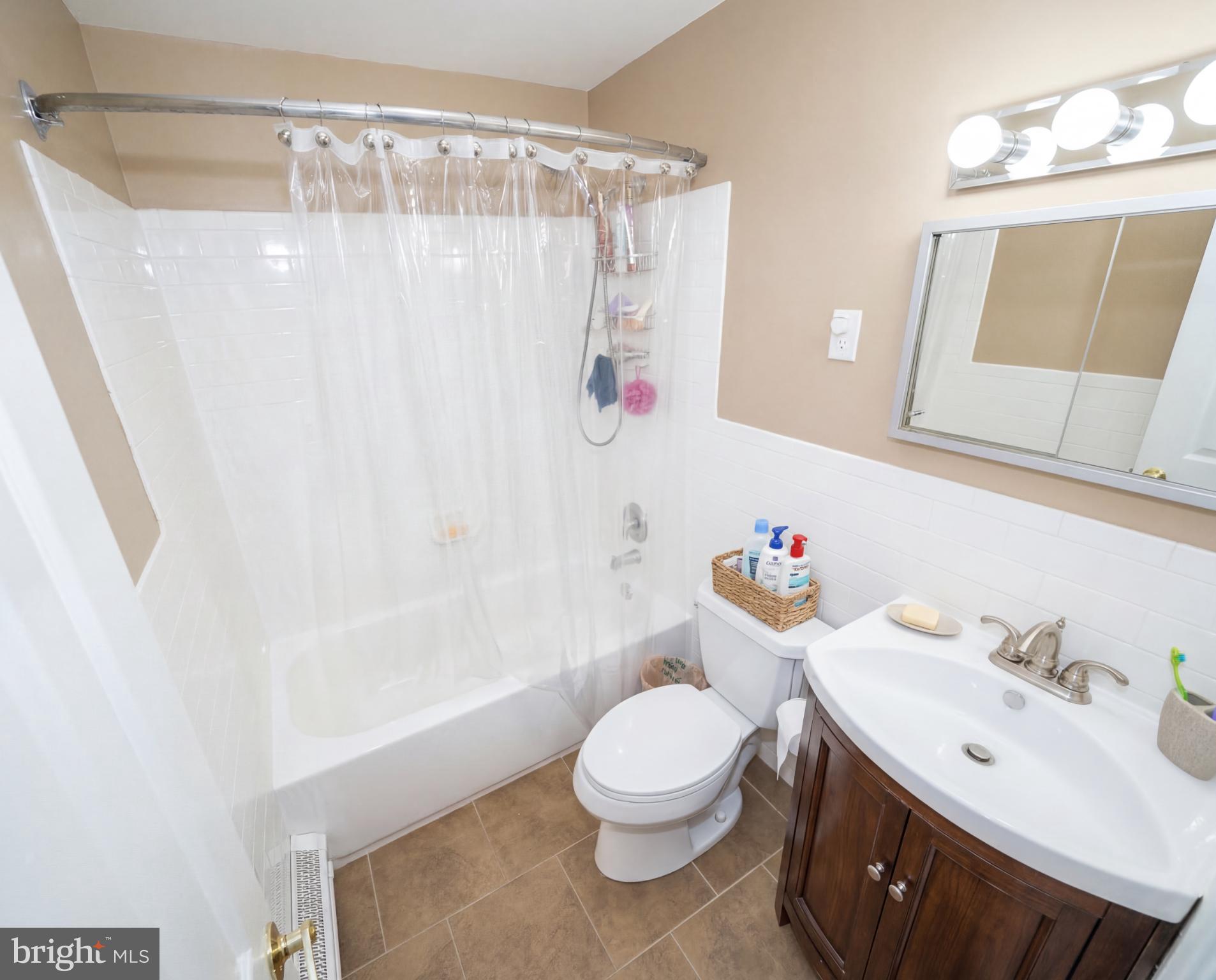 3216 Chesterfield Road Philadelphia, PA 19114 - Photo 16 of 27 a bathroom with a sink a toilet and shower curtain