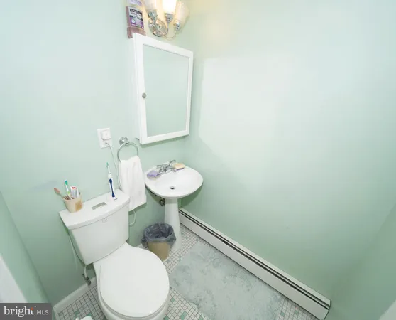 a white toilet sitting next to a bathroom sink
