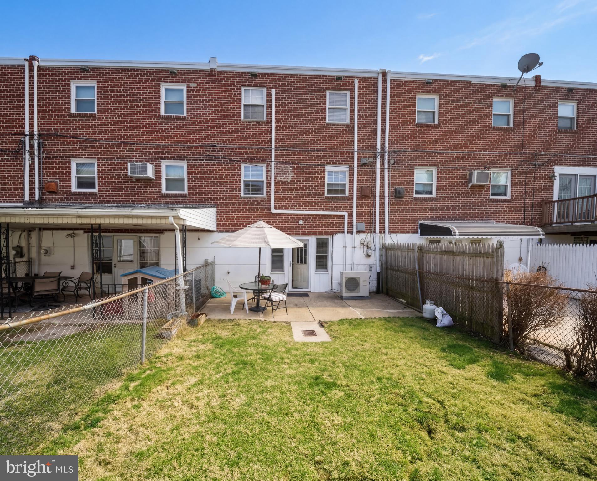 3216 Chesterfield Road Philadelphia, PA 19114 - Photo 27 of 27 a view of a brick building with many windows and lawn chairs