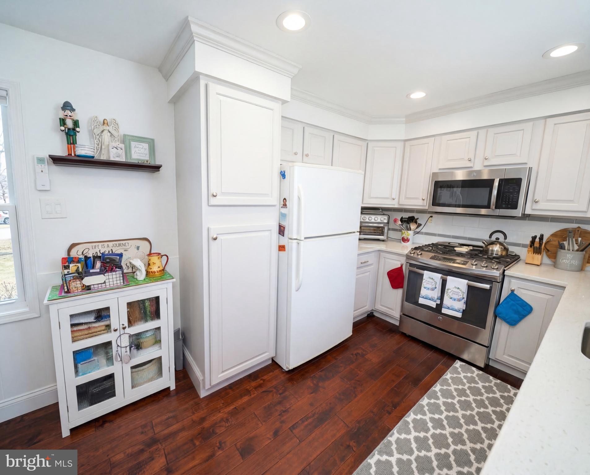 3216 Chesterfield Road Philadelphia, PA 19114 - Photo 9 of 27 a kitchen with a refrigerator stove and wooden floor