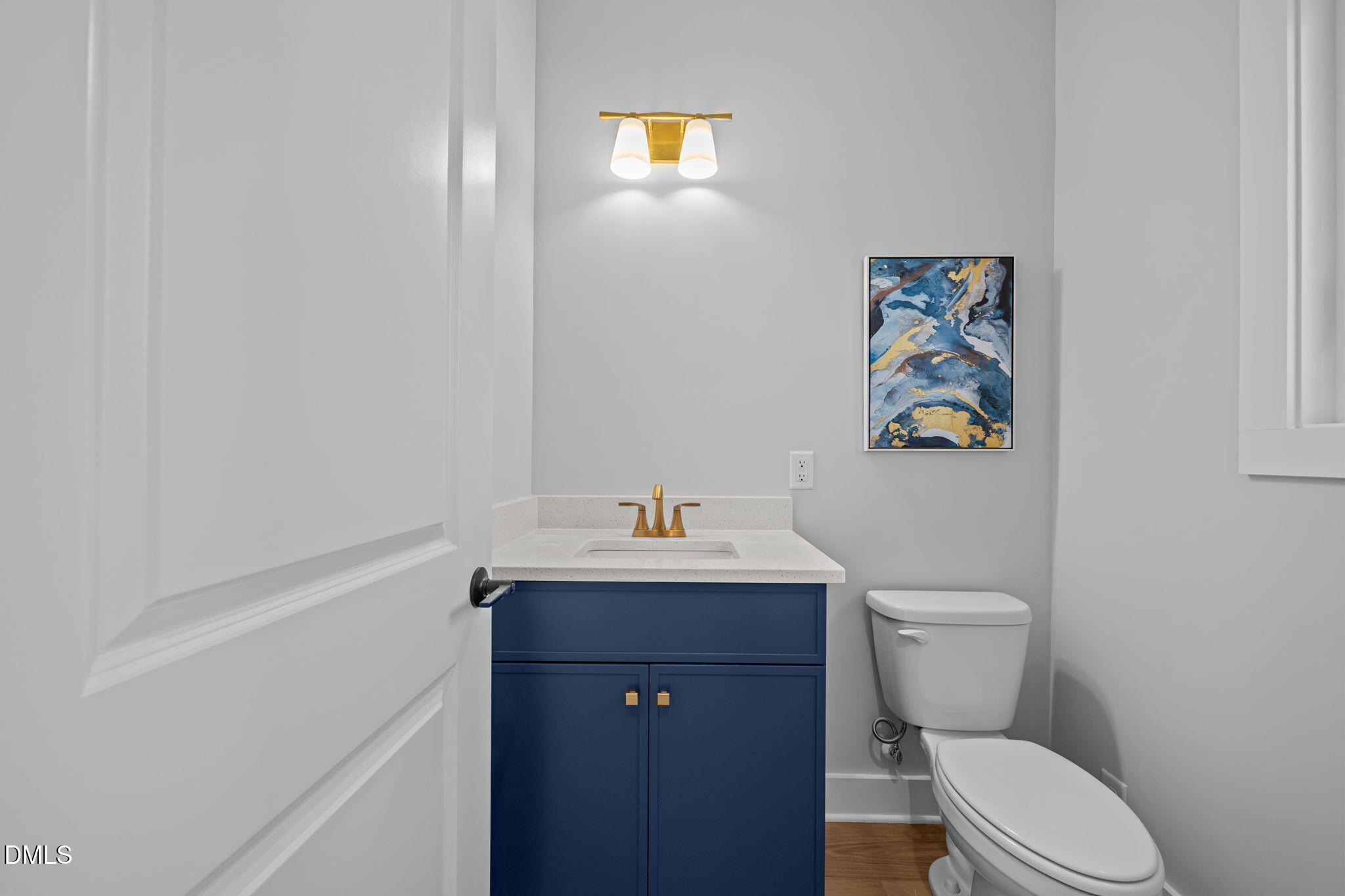 1005 Phoenix Place Raleigh, NC 27610 - Photo 14 of 38 a bathroom with a toilet a sink and mirror