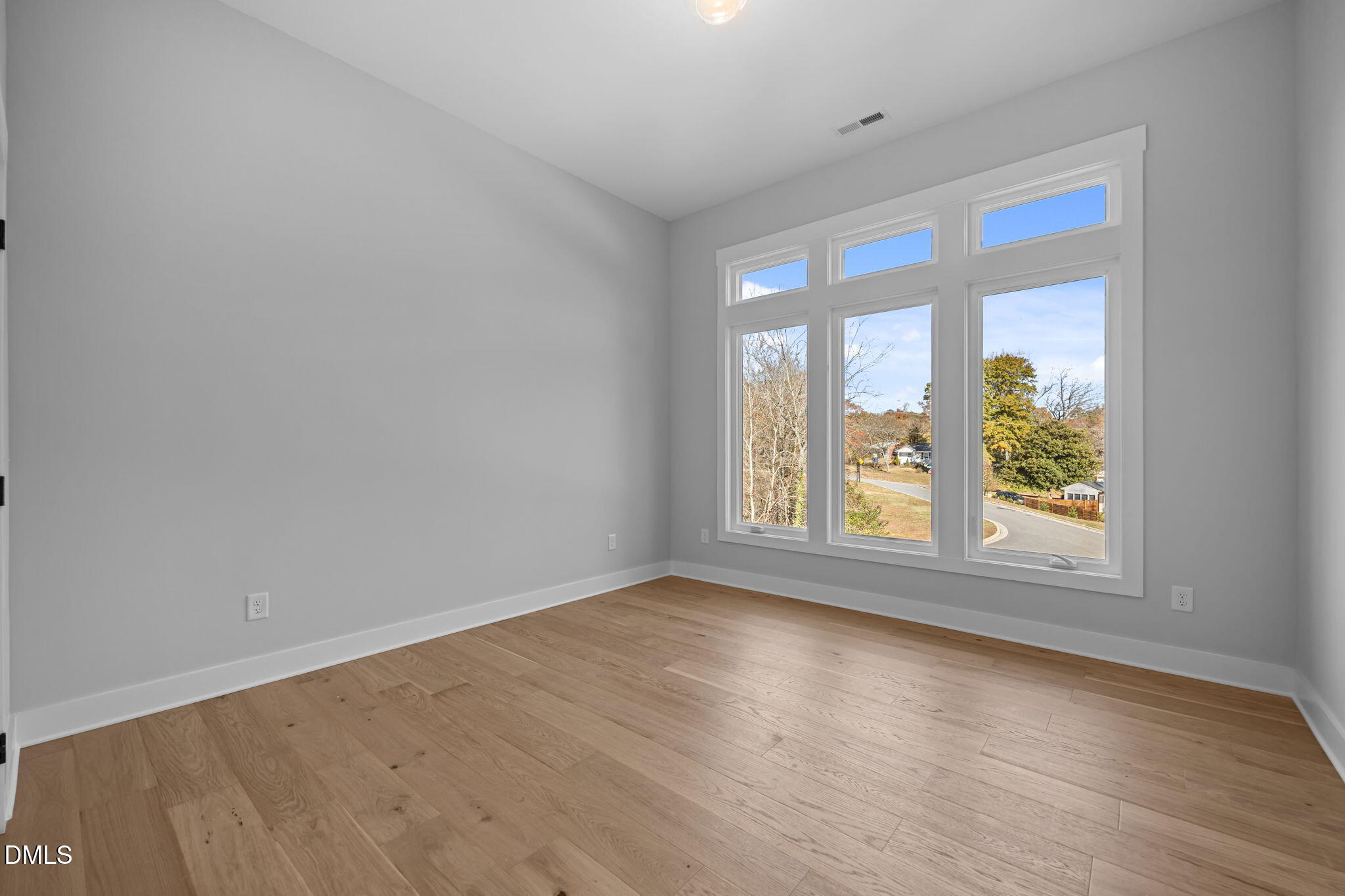 1005 Phoenix Place Raleigh, NC 27610 - Photo 20 of 38 an empty room with wooden floor and windows