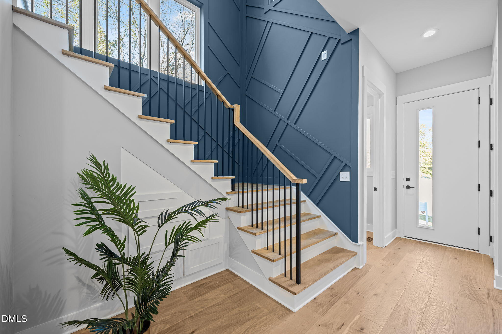 1005 Phoenix Place Raleigh, NC 27610 - Photo 4 of 38 a view of entryway with wooden floor and stairs