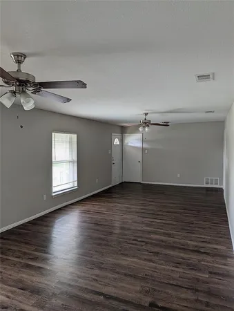 a view of a room with wooden floor and white walls