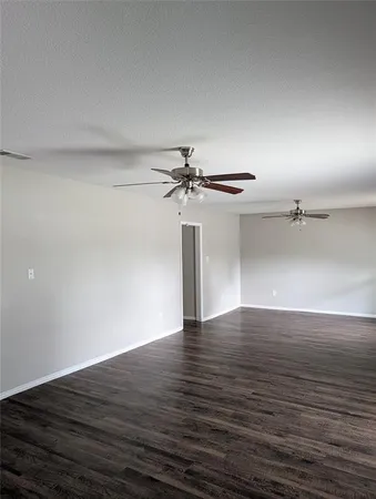 a view of a room with wooden floor