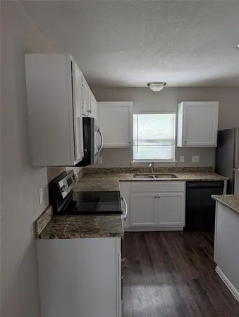 a kitchen with a sink stove and microwave