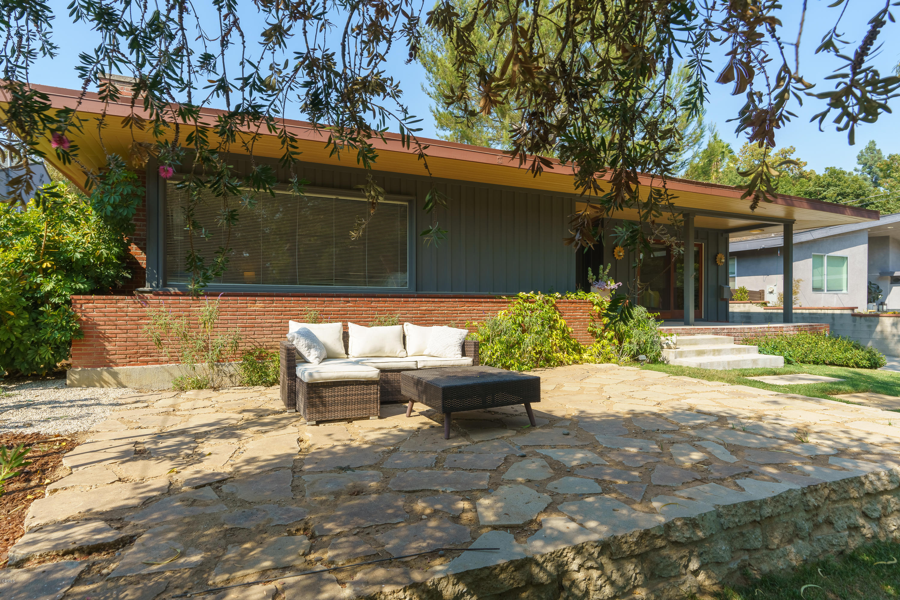 1025 Nithsdale Road Pasadena, CA 91105 - Photo 2 of 34 a backyard of a house with outdoor seating and a tree
