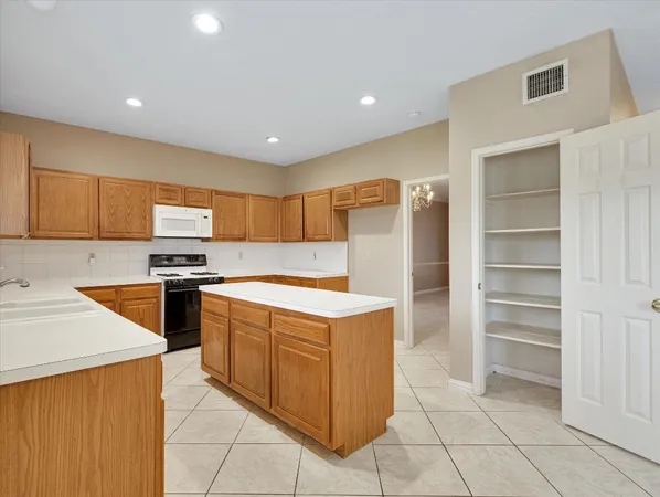 a kitchen with stainless steel appliances granite countertop a sink counter space cabinets and a large window